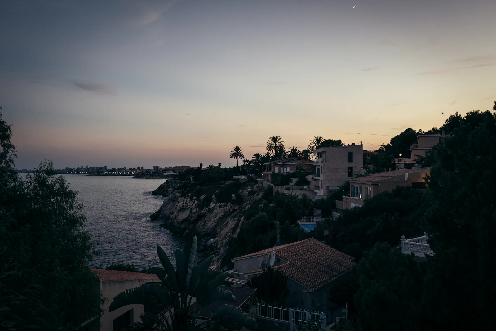 A Mediterranean coastal town at dusk