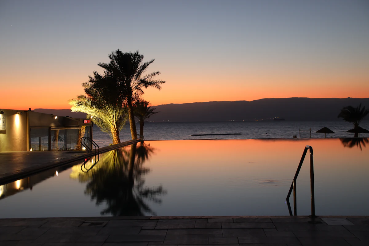 Infinity pool mirroring the sunset